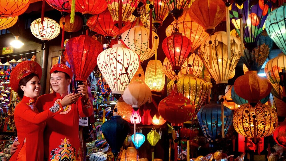 Lanterns glowing along Hoi An's river at night