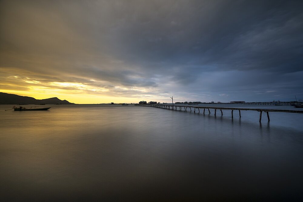 Phu Quoc island at sunrise, calm water and a wooden pier