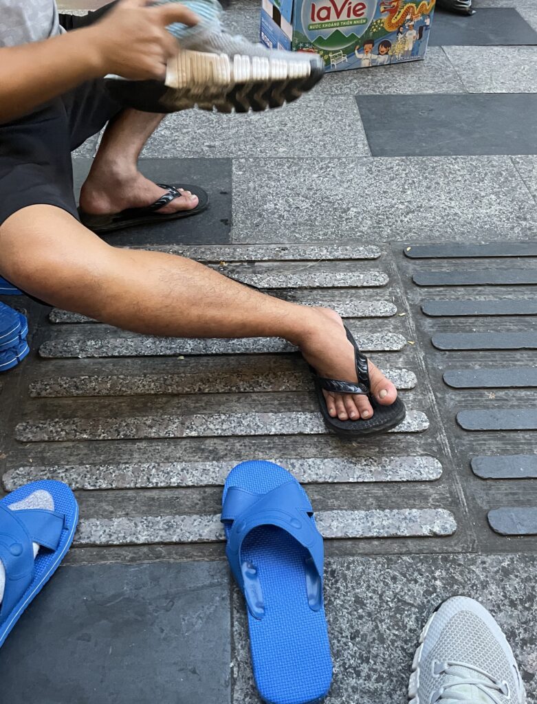 Shoe shiner on the street in Ho Chi Minh City