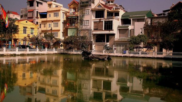 Wreckage of a B-52 bomber in Huu Tiep Lake, surrounded by houses, Hanoi