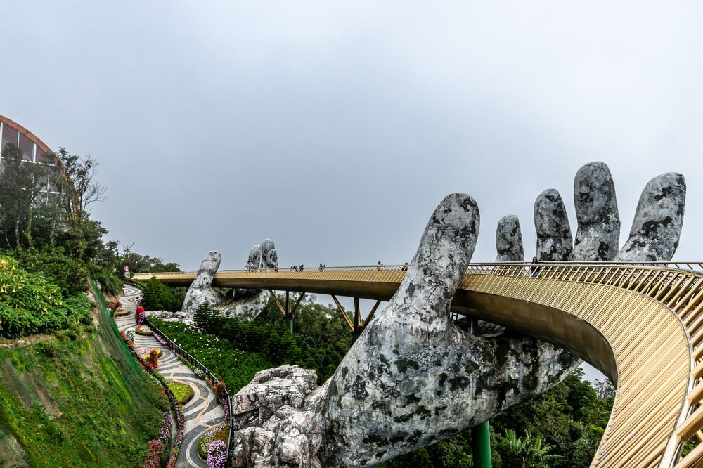 The Golden Bridge at Ba Na Hills, held by giant stone hands above the clouds