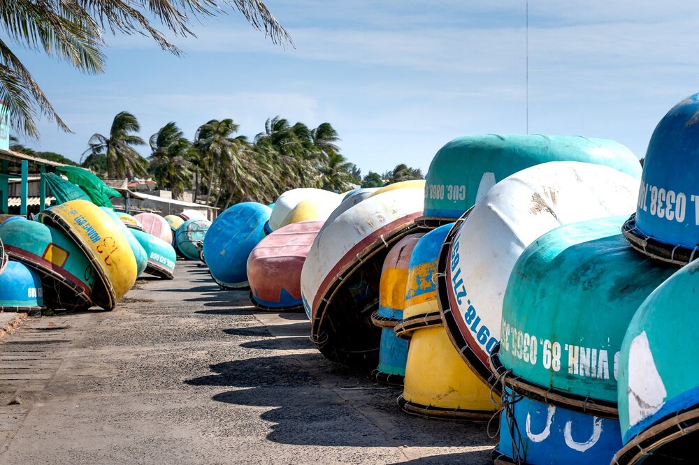 Mui Ne fishing village with colourful round basket boats at sunrise