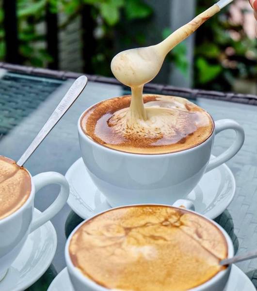 Egg coffee served in a small cup at a Hanoi café