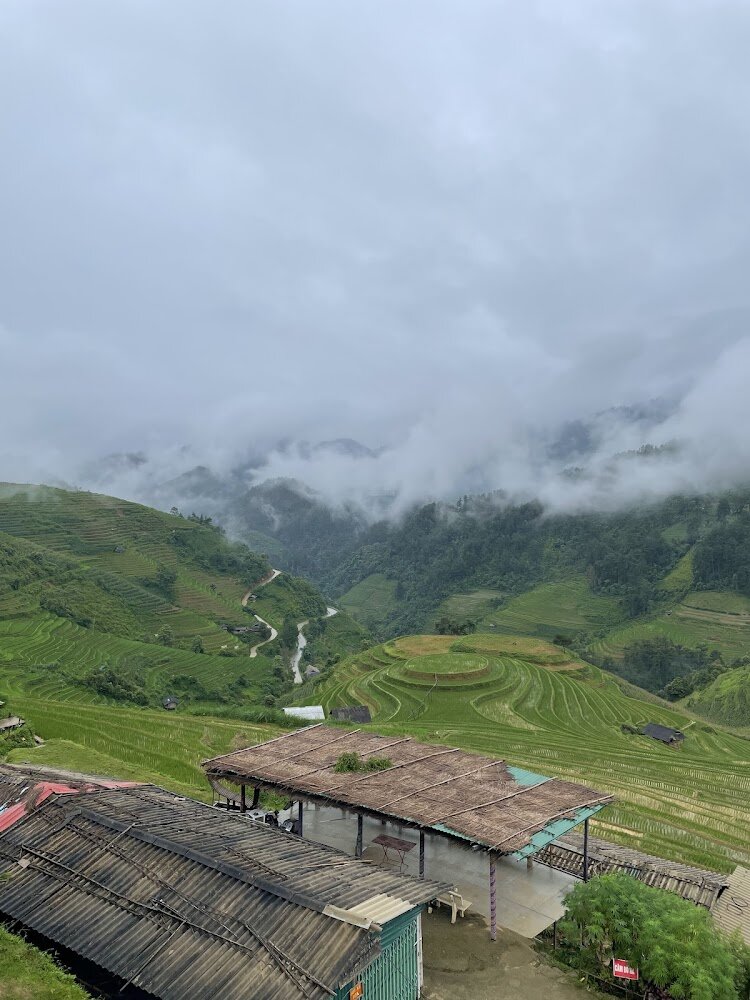 Green terraces around Mam Xoi Hill under rain cloud in Mu Cang Chai in July