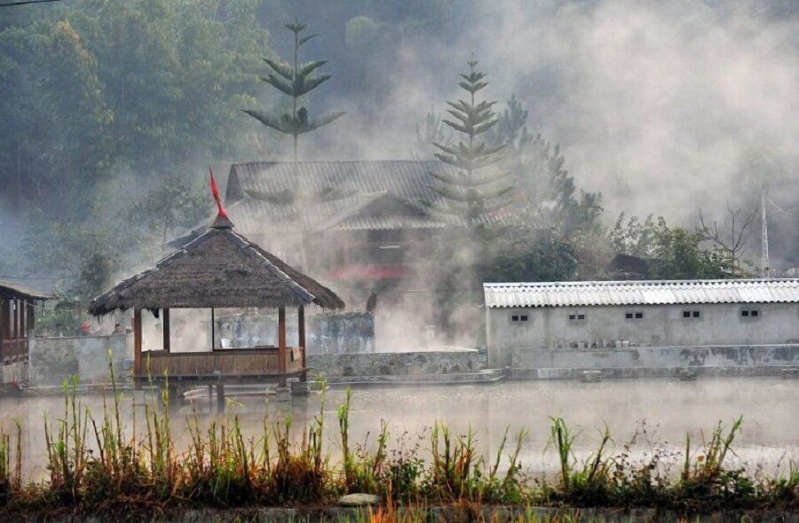 Steam rising from an outdoor hot-spring pool on a cold December morning