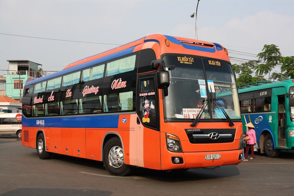 Orange Hyundai sleeper bus at a Vietnam bus station
