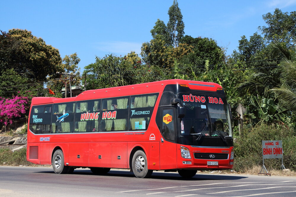 Red Tracomeco sleeper bus on a Vietnam highway