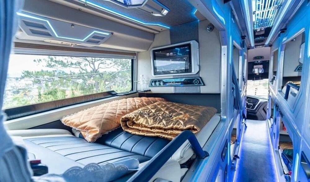 Inside a VIP cabin sleeper bus pod with full-flat bed, TV screen and large window