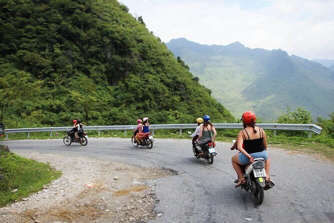 Travellers riding motorbikes on a mountain road in northern Vietnam